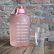 Pink gallon water jug beside glass of water